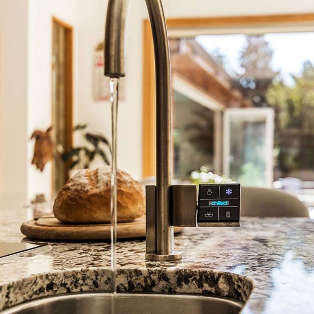 Quatreau touchscreen kitchen tap in brushed stainless steel finish in domestic kitchen